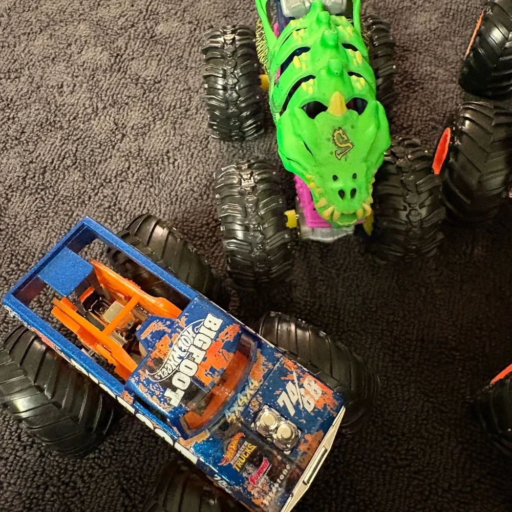 Hot Wheels 4 lot of Monster Truck Toys. Assorted Colors (Green, Orange, Blue)